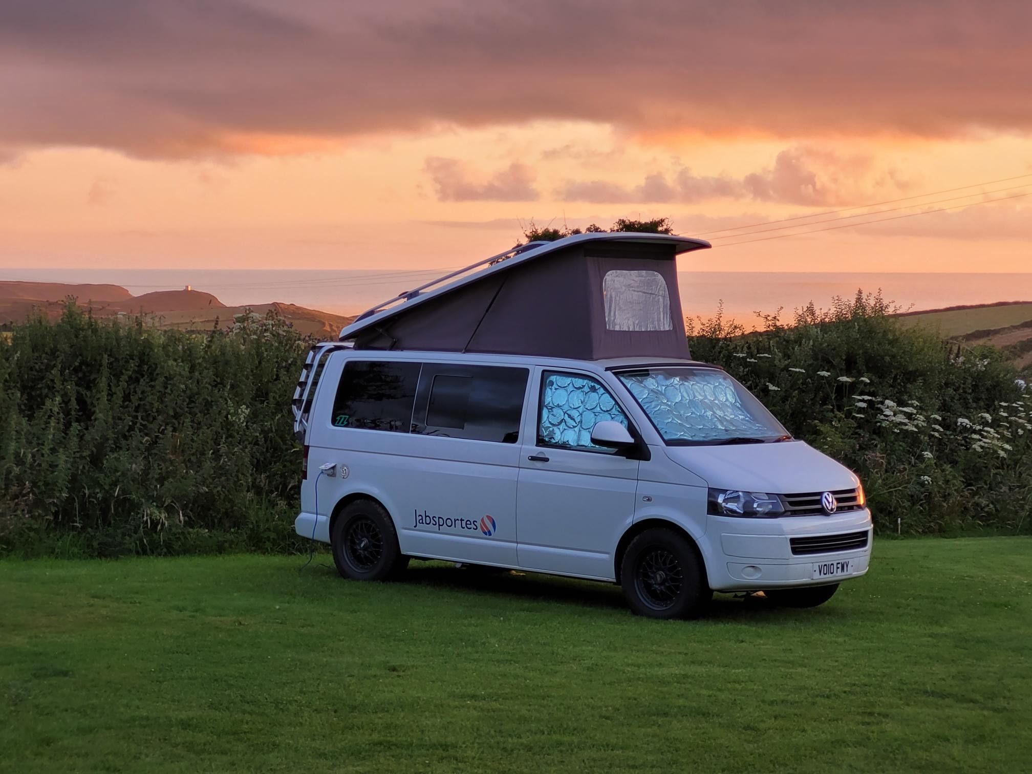 A VW T5 Campervan called SnowBall-0526 and Boscastle sunset for hire in Newquay, Cornwall