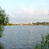View over Sale Water Park, taken in May 2007, from the north east of the lake, on the edge of Broad Ees Dole, looking towards Deckers. The bridge in the far background, behind the water sports centre and restaurant complex, is a footbridge over the M60.
