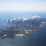 Guernsey from the air. Viewed from a flight from Gloucester to Jersey. Here we are looking at the sandy bay on the north coast of the island by the Royal Guernsey Golf Club.