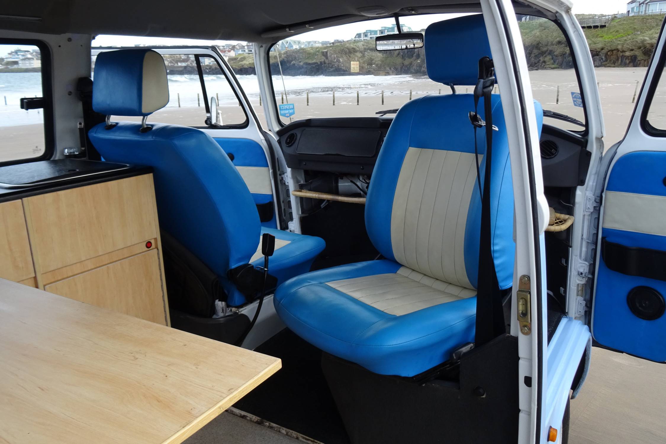 A VW T2 Brazilian Campervan called Flo and Driver's seat swivels to face the inside cabin for hire in Portstewart, Derry