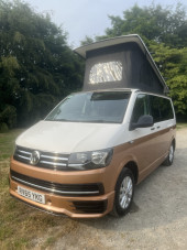 A VW T6 Campervan called Snug and Front - Showing WestDubs Pop up Roof for hire
